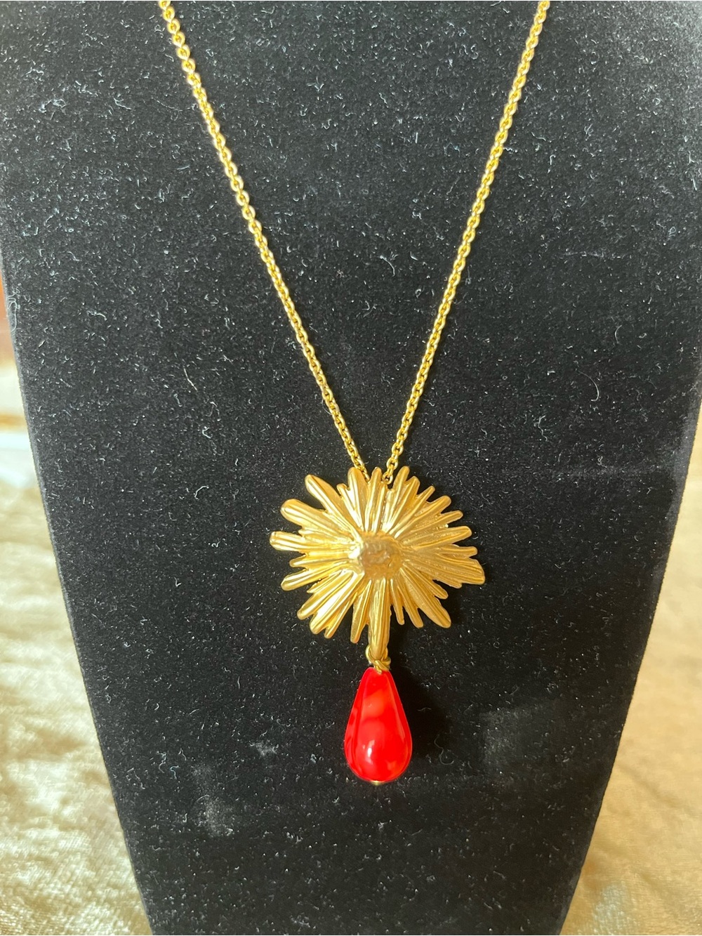 Gold Sunburst Pendant Necklace with a Dangling Teardrop Accent